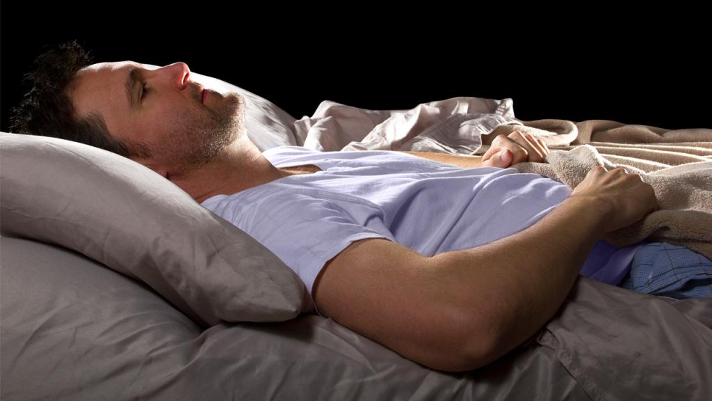 Man lying in bed with insomnia