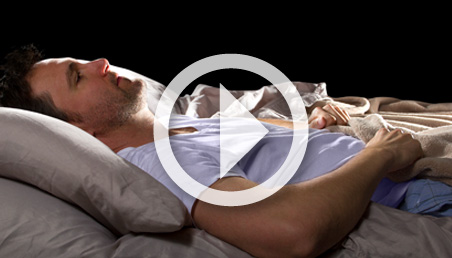 Man lying in bed with insomnia