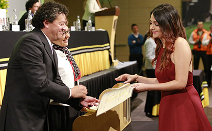 Graduanda recibiendo diploma de la Universidad de los Andes